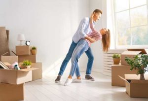 Couple dancing together in their new home