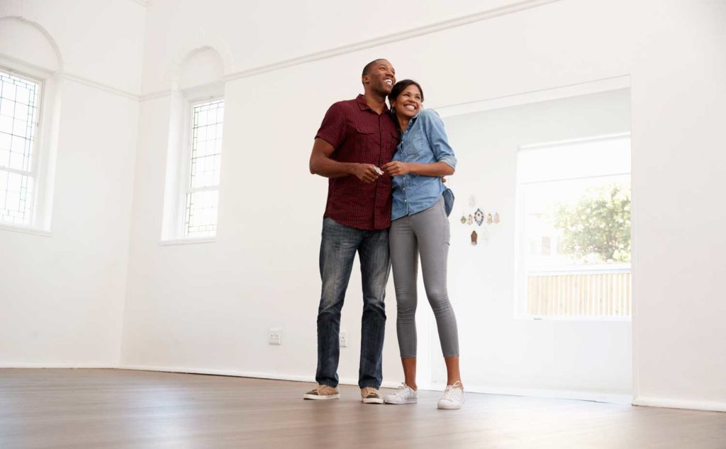 Excited young couple approved for a mortgage and moving into their new home