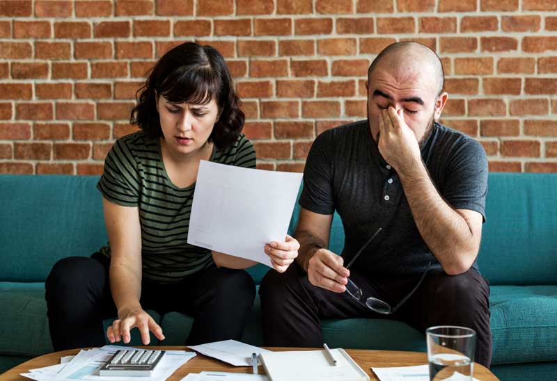 Stressed couple trying to manage their debt
